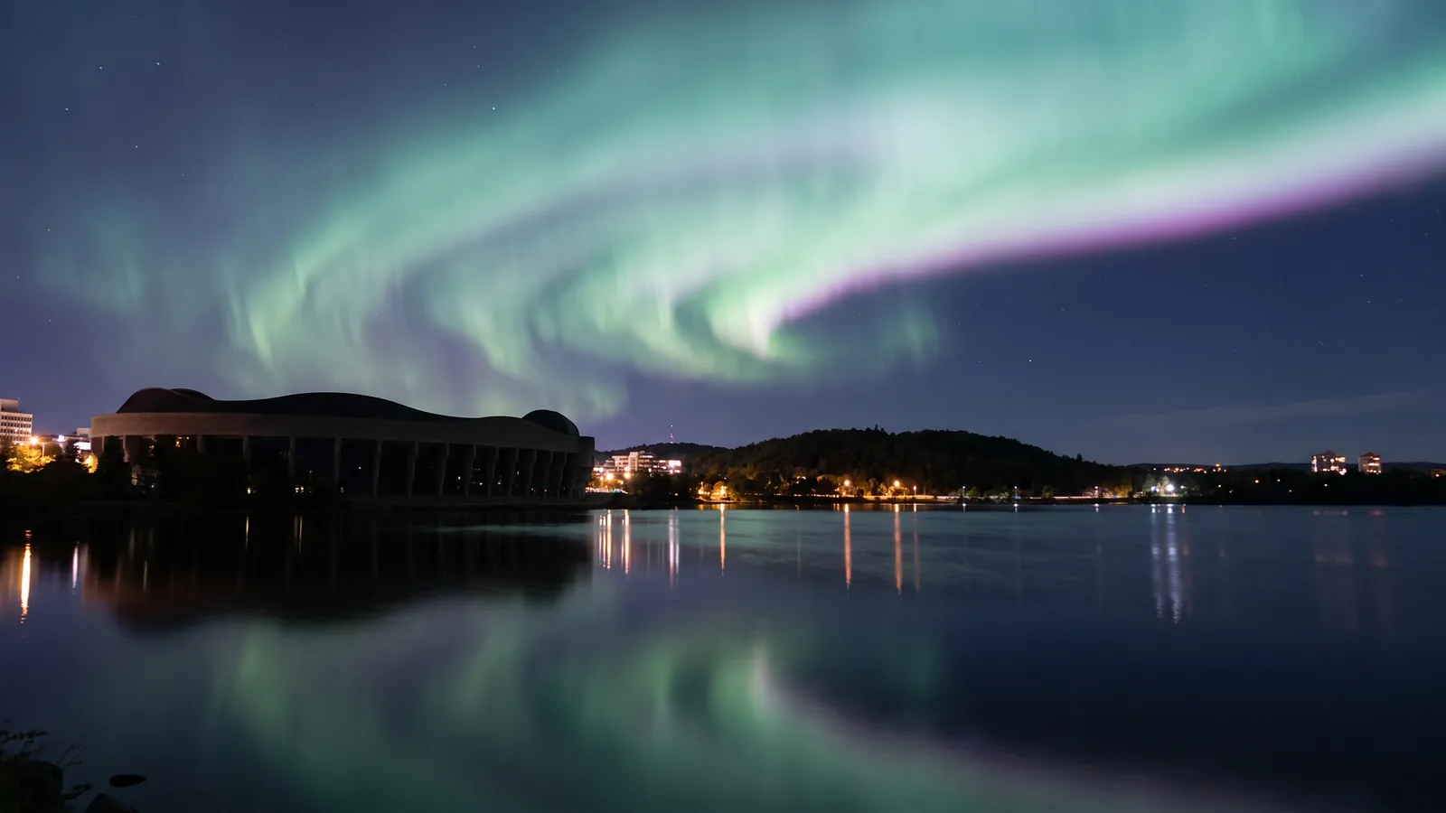 Gatineau at night under the northern lights, seen from the Ottawa River