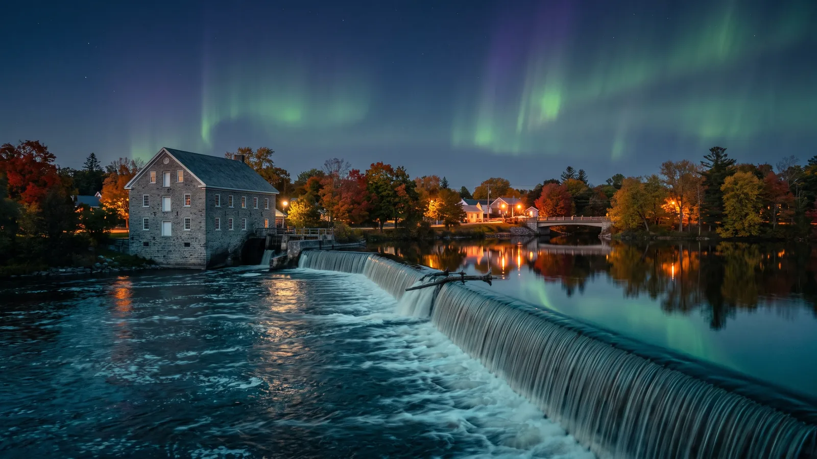 Watson's Mill on the Rideau River in Manotick at dusk under the northern lights