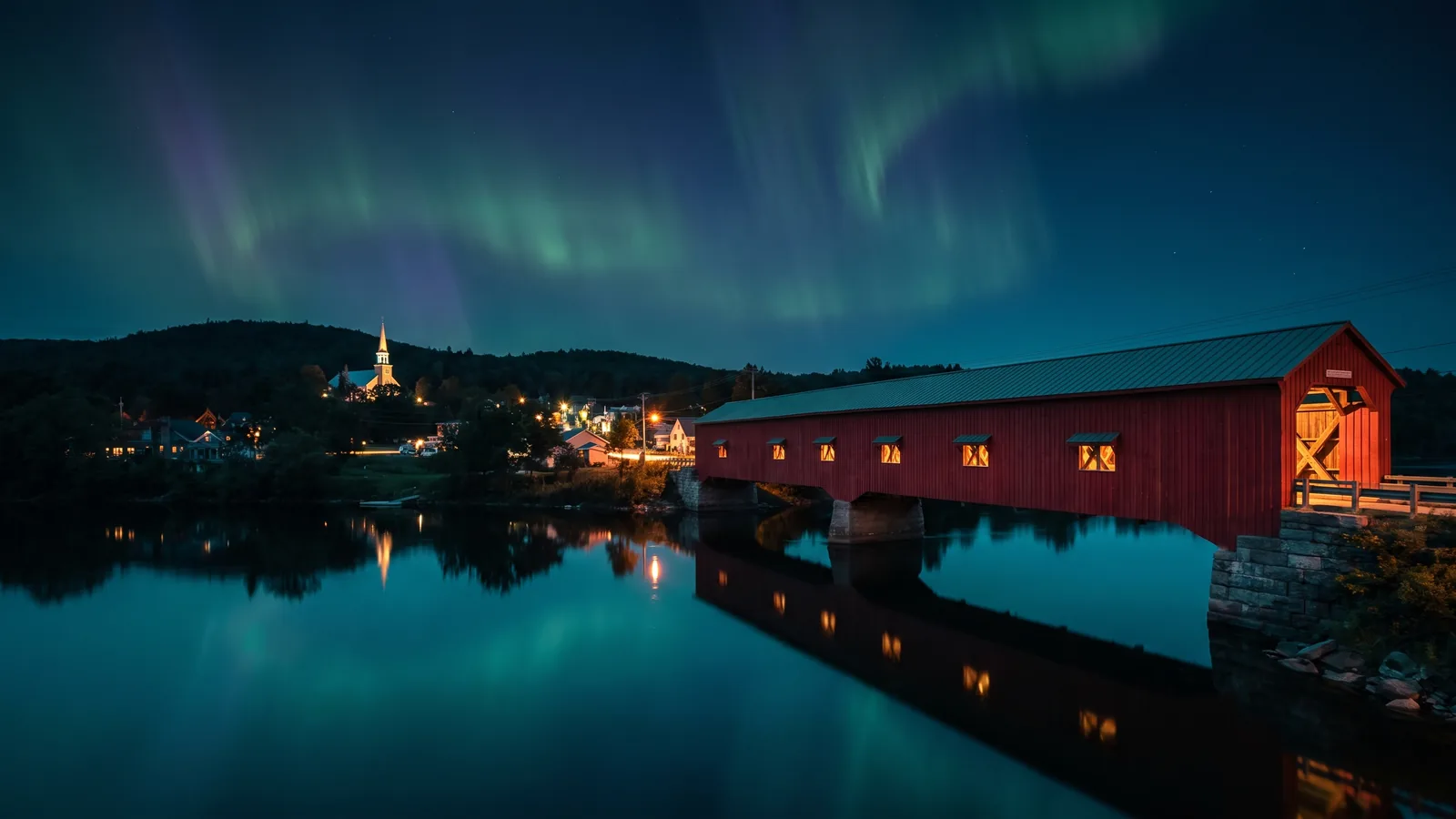 The Wakefield covered bridge over the Gatineau River at blue hour under the northern lights